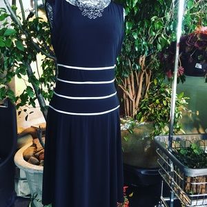 Women’s black dress with white piping accent